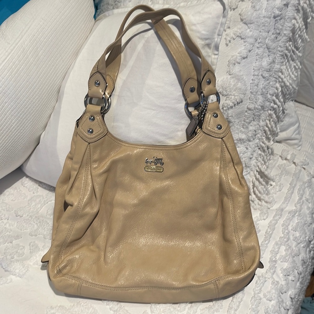 Older style coach handbag. Used but in good condition. Three pocket interior.